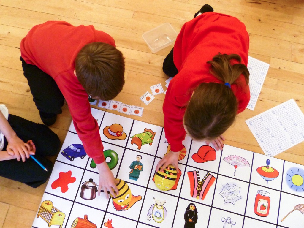 Pupils working with a Bee-Bot and 'fakebot'.